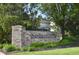 Elegant stone sign marking the entrance to Sandstone Lakes community, surrounded by lush landscaping at 11850 Stepping Stone Dr, Fishers, IN 46037