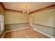 Dining room showcasing the wooden floors, trim, and classic chandelier at 11850 Stepping Stone Dr, Fishers, IN 46037