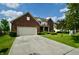 Charming two-story brick home featuring an attached two-car garage and a well-manicured front yard at 11850 Stepping Stone Dr, Fishers, IN 46037