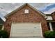 Detailed view of a brick home's garage door, highlighting its design at 11850 Stepping Stone Dr, Fishers, IN 46037