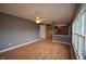 Open-concept living room boasts hardwood floors, ceiling fan, and a view of the kitchen at 11850 Stepping Stone Dr, Fishers, IN 46037