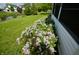 Yard featuring lilac bushes, and a view of the nearby pond at 11850 Stepping Stone Dr, Fishers, IN 46037
