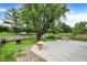 A spacious backyard features a wooden deck with built-in benches and a large tree, perfect for outdoor entertaining at 12257 Driftstone Dr, Fishers, IN 46037