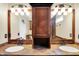 Dual sink bathroom with a wooden vanity and framed mirrors at 12257 Driftstone Dr, Fishers, IN 46037
