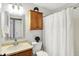 Bathroom features a vanity, mirror, toilet, medicine cabinet, and shower with a decorative curtain at 12257 Driftstone Dr, Fishers, IN 46037