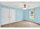 Light-filled bedroom featuring a ceiling fan, plush carpet, and two closets at 12257 Driftstone Dr, Fishers, IN 46037