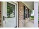 Inviting front porch featuring brick accents, decorative shutters, and charming hanging plants at 12257 Driftstone Dr, Fishers, IN 46037