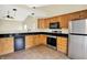 Well-equipped kitchen featuring stainless steel appliances, tiled flooring, and wood cabinetry at 12257 Driftstone Dr, Fishers, IN 46037