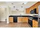 Modern kitchen with stainless steel appliances, granite countertops, and wood cabinetry at 12257 Driftstone Dr, Fishers, IN 46037