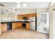 Open kitchen with stainless steel appliances, granite countertops and tile floors at 12257 Driftstone Dr, Fishers, IN 46037