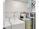 Laundry room area featuring a washer, dryer, water filtration system, and utility shelving at 12257 Driftstone Dr, Fishers, IN 46037