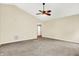 Spacious living room featuring neutral carpet, ceiling fan, and vaulted ceilings at 12257 Driftstone Dr, Fishers, IN 46037