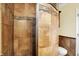 Elegant shower featuring earth-toned tiling with a decorative mosaic tile accent stripe at 12257 Driftstone Dr, Fishers, IN 46037