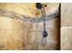 Close-up of a shower featuring stylish, earth-toned tiles with a decorative mosaic accent and a bronze shower head at 12257 Driftstone Dr, Fishers, IN 46037
