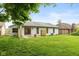 Charming home exterior with a well-maintained lawn, patio, and serene backyard at 12290 Charing Cross Rd, Carmel, IN 46033