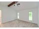 Spacious bedroom has a vaulted ceiling with a wooden beam and two windows at 12290 Charing Cross Rd, Carmel, IN 46033