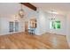 Open-concept dining area with hardwood floors, modern lighting fixtures, and breakfast bar with stools at 12290 Charing Cross Rd, Carmel, IN 46033