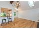 Open-concept dining area with hardwood floors, modern lighting fixtures, and breakfast bar with stools at 12290 Charing Cross Rd, Carmel, IN 46033