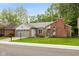 Charming single-story home with a brick chimney, gray siding, well-maintained lawn, and an attached two-car garage at 12290 Charing Cross Rd, Carmel, IN 46033