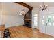Bright living room features hardwood floors, a skylight, and a striking brick fireplace with a rustic wood beam at 12290 Charing Cross Rd, Carmel, IN 46033