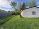 Home's backyard is partially fenced and has a detached garage with green grass at 128 Coronado Rd, Indianapolis, IN 46234
