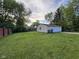 Spacious backyard featuring a detached garage with ample lawn area at 128 Coronado Rd, Indianapolis, IN 46234