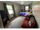 A bedroom is spacious and contains a bed and red futon couch at 128 Coronado Rd, Indianapolis, IN 46234