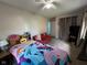 Cozy bedroom features comfortable seating, ceiling fan and colorful decor creating an inviting space at 128 Coronado Rd, Indianapolis, IN 46234