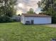 White detached garage has a two car wide garage door and a single door entrance from the backyard at 128 Coronado Rd, Indianapolis, IN 46234