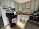 A kitchen with gray cabinets and a black gas oven and range at 128 Coronado Rd, Indianapolis, IN 46234