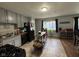 Well-lit kitchen featuring gray cabinets, black appliances, and a functional island at 128 Coronado Rd, Indianapolis, IN 46234