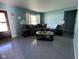 Bright living room with modern gray flooring, a plush sectional, and natural light at 128 Coronado Rd, Indianapolis, IN 46234