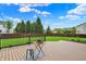 Cozy backyard deck with a grill, offering a relaxed setting with a view of the fenced yard at 13209 Westwood Ln, Fishers, IN 46038