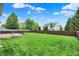 Expansive backyard featuring a lush lawn, wooden fence, and deck ideal for outdoor entertaining and relaxation at 13209 Westwood Ln, Fishers, IN 46038
