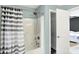 Shower area with striped curtain, shower head and doorway to bedroom at 13209 Westwood Ln, Fishers, IN 46038