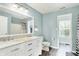 Bathroom with a double vanity sink, toilet, and shower with curtain at 13209 Westwood Ln, Fishers, IN 46038