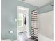 Bathroom with toilet, shower with striped curtain and view to closet at 13209 Westwood Ln, Fishers, IN 46038