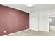 Well-lit bedroom showcasing a stylish accent wall and an open doorway at 13209 Westwood Ln, Fishers, IN 46038
