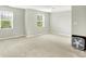 Bedroom with neutral colored carpet, white walls, two windows with blinds, and a floor fan at 13209 Westwood Ln, Fishers, IN 46038