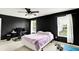 Well lit bedroom with a ceiling fan, two windows, and a bed at 13209 Westwood Ln, Fishers, IN 46038