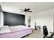 Bright bedroom featuring ceiling fan, and open doorway to bathroom at 13209 Westwood Ln, Fishers, IN 46038