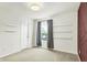 Spacious bedroom with a neutral carpet, natural light, and sleek, modern shelving at 13209 Westwood Ln, Fishers, IN 46038