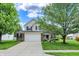 Charming two-story home featuring a well-manicured front yard and an attached two-car garage at 13209 Westwood Ln, Fishers, IN 46038