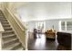Open concept living area adjacent to the staircase and dining area with hardwood flooring at 13209 Westwood Ln, Fishers, IN 46038