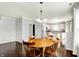 Bright living room featuring wood floors, table, and an open kitchen area at 13209 Westwood Ln, Fishers, IN 46038