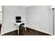 Office area with a white desk, computer, dark hardwood floors, gray walls, and a black folding chair at 13209 Westwood Ln, Fishers, IN 46038