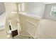 Hallway and staircase with neutral color scheme, natural light, and carpeted stairs at 13209 Westwood Ln, Fishers, IN 46038