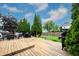 Spacious wooden deck features outdoor seating, a grill, and lovely landscaping for outdoor entertaining at 14030 Avalon East Dr, Fishers, IN 46037