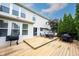 Outdoor deck area features wood flooring, patio furniture, grill, and backyard landscaping, with vinyl siding and blue sky above at 14030 Avalon East Dr, Fishers, IN 46037