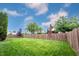 Expansive fenced backyard featuring lush green grass and mature trees providing shade at 14030 Avalon East Dr, Fishers, IN 46037